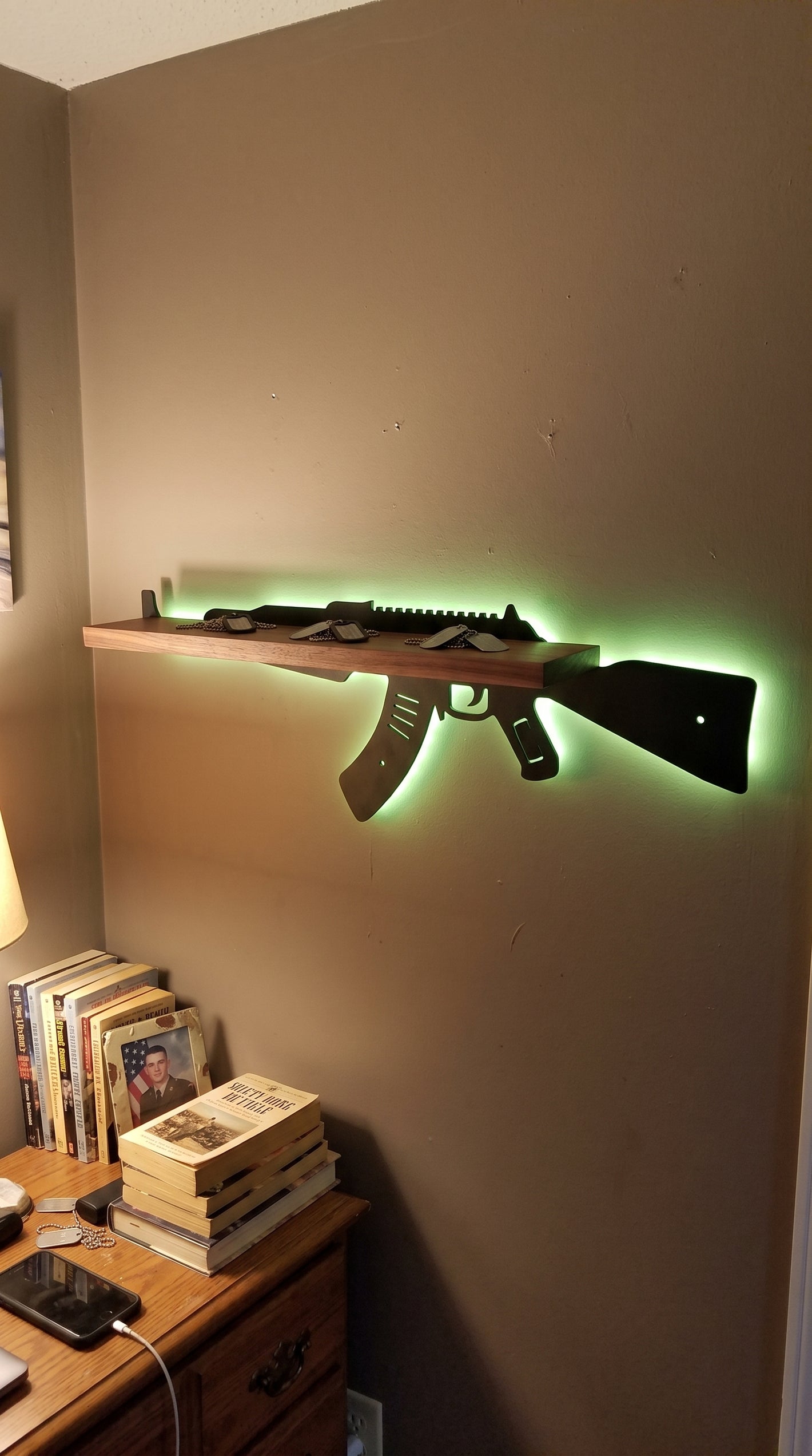 AK-47 style LED shelf over a desk, green